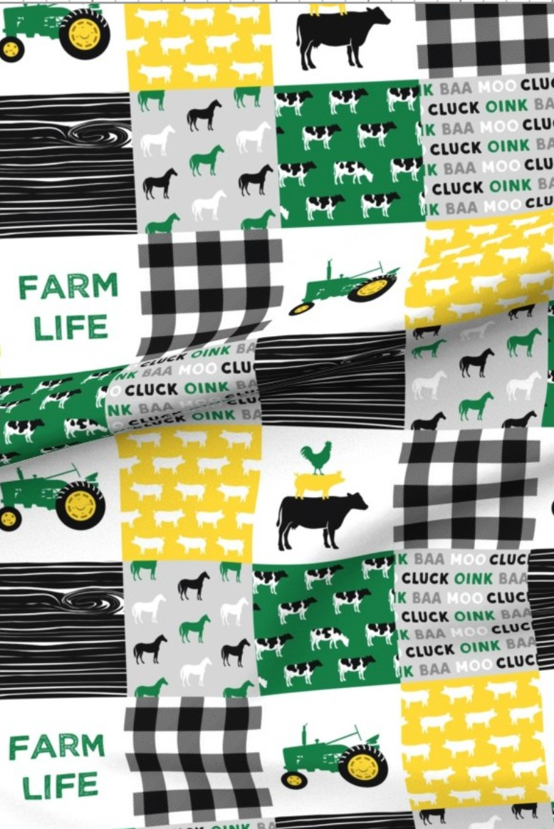 Farm Life minky fabric — patchwork squares of green tractors, cows and horses with black and white buffalo check and wood grain, and the words farm life and cluck oink baa moo