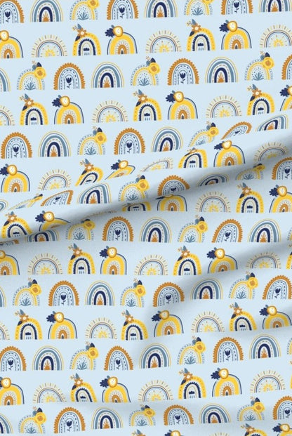 Blue and Yellow Rainbows premium minky fabric — rows of little rainbows in yellow and navy on a soft blue background