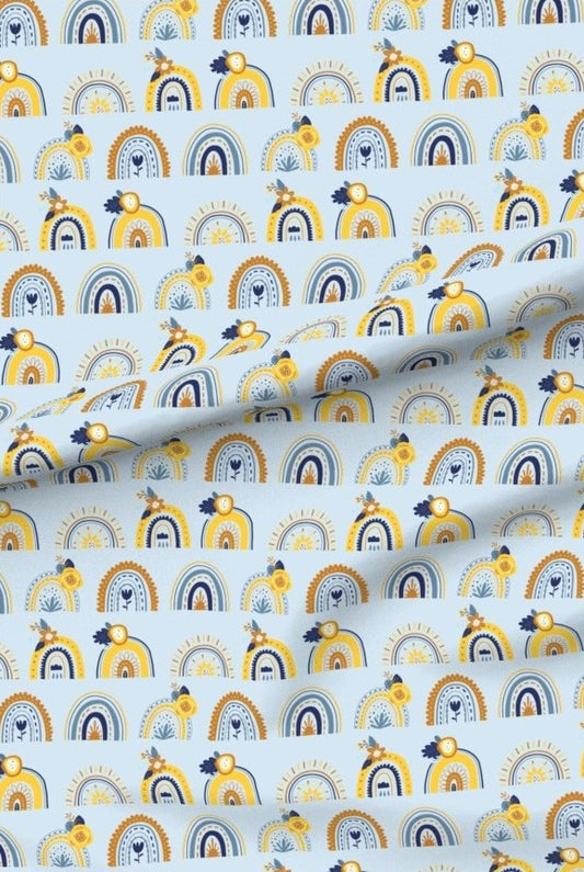 Blue and Yellow Rainbows premium minky fabric — rows of little rainbows in yellow and navy on a soft blue background